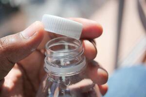 open a cap of a plastic water bottle photo