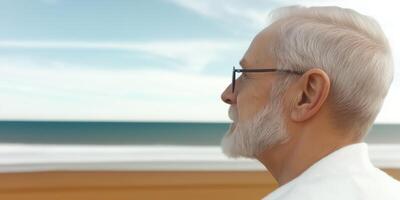 Senior man gazing at ocean view photo