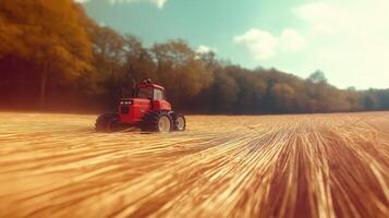 Red tractor in golden field, rural scene photo