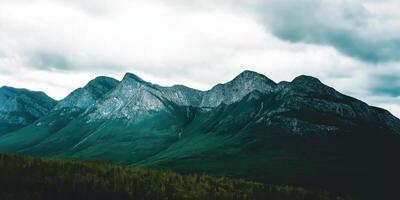 Majestic mountains under a cloudy sky photo