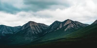 Majestic mountain range under cloudy sky photo