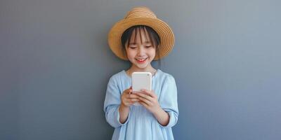 A little girl in a hat is holding a smart phone photo