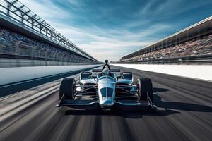 Racecar driver driving on a racetrack with blurred spectators photo