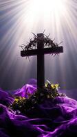 Crown of thorns on wooden cross with purple cloth and light rays symbolizing jesus christ's sacrifice photo