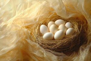 Fresh eggs nestled in hay covered by delicate gold cloth photo