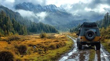 Off-road vehicle exploring muddy path in mountain valley wilderness photo