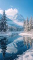 Snowy mountain reflecting in a glacial lake surrounded by pine trees photo