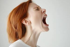 Woman expressing intense emotion while screaming in a minimalistic indoor setting photo