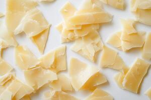 Chipped white chocolate pieces scattered on a white background photo