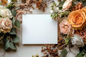 Elegant arrangement of flowers surrounding a blank card for personal messages and invitations photo