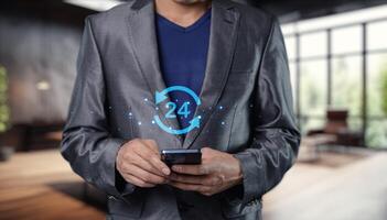 Businessman in suit holding smart phone with blue icon on screen photo