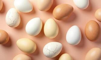 Assorted eggs Various colors and textures Peach background photo