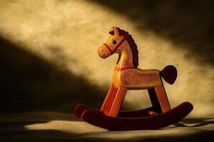 A charming wooden rocking horse is illuminated by soft, warm light casting gentle shadows. This nostalgic toy adds a playful touch to a childs room, inviting imagination and joy. photo