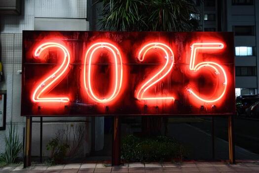 A large neon sign illuminated with the year 2025 stands out against the night sky in an urban area. Surrounding buildings create a modern backdrop, while palm trees add a tropical touch. photo