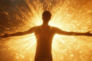 A man stands with arms wide open, silhouetted against a dazzling explosion of golden light. This vibrant display creates a powerful atmosphere of joy and freedom, inspiring awe. photo
