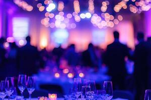 Guests enjoy a festive atmosphere at a well-decorated venue featuring soft purple lighting and elegantly arranged tables. Candles flicker and create a warm ambiance for the celebration. photo