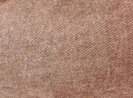 Rich mocha-toned denim jeans textile for any background. Faded fabric jeans. Denim Material. Canvas denim jeans texture. Mocha Mousse Color of the Year 2025. photo