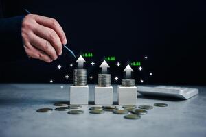 Businessmen use pen points to income and return on investment in a stack of coins. photo