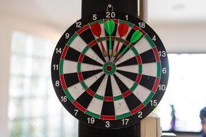 Dartboard for darts game and four darts. photo