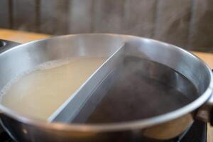 Hot pot with two kinds of soup in one pot photo