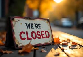 we're closed sign on a bench photo