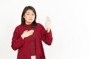 Swearing or Promise Gesture Of Beautiful Asian Woman Wearing Red Shirt Isolated On White Background photo