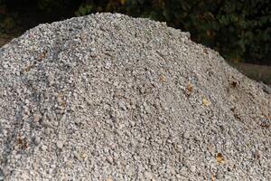 Construction sand. A mountain of loose material. Details of a construction site. photo