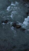 River Arve flowing around rocks in Chamonix, France in November video