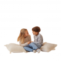 Two children laughing and playing together on soft pillows, creating joyful memories. png