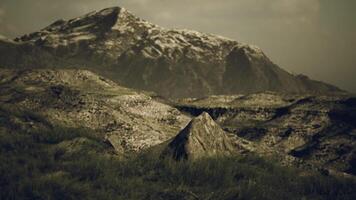 Majestic mountain landscape with rocky terrain and soft grass in daytime video