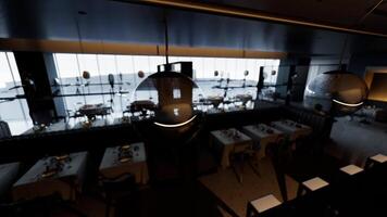Empty upscale restaurant with tables set for dinner during twilight hours video