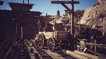 Wooden wagon on rustic dock with mountains in the background during daylight video