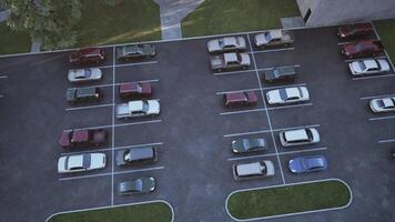 Aerial view of a busy parking lot filled with various vehicles during daytime video