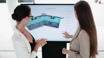Multi-Ethnic Business women discussing a analytical 3D Graphics Project. Visualization, Digitalization of Condominium, house Design. AI digital advertisement navigator direction for Real estate agency video