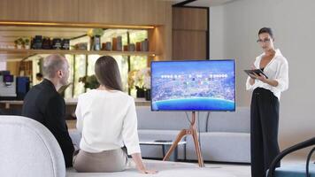 Multi-Ethnic people discussing Digital Interactive Whiteboard with real estate Data. Asian businesswoman in classic suit talking, using TV with Infographics, Statistics. AI Visualization video