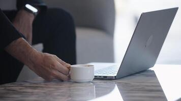 Hands of Busy middle aged business man sitting at desk using laptop. Mature serious professional businessman manager working with computer technology and cup of coffee in office. video
