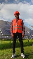 African American engineer in uniform in solar power station. Vertical video