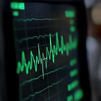 Close-up of a heart monitor displaying a green ECG waveform. Medical technology concept with vital signs on a screen. photo