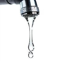Water droplet emerging from a faucet against a pure white background. photo