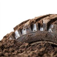 Muddy tire on white background, perfect for automotive and adventure themes. photo