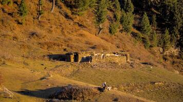 Rustic Hut in a Mountain Landscape with a Lone Figure photo