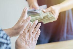 Shot of a person refusing bribe given money by partner with anti bribery corruption concept. photo
