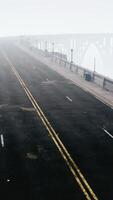An empty illuminated asphalt road in a thick fog video