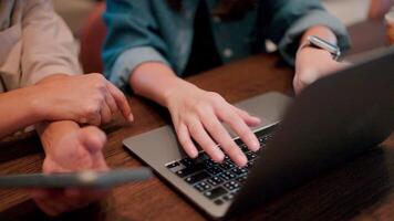 Close Collaboration. A pair of hands, one on a tablet and the other on a laptop, work in tandem, showcasing the collaborative spirit of modern work. video