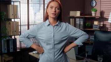 Confident Caucasian business woman girl female businesswoman employer manager company worker in office authoritative dissatisfied put hands to sides akimbo power pose confidence looking at camera video