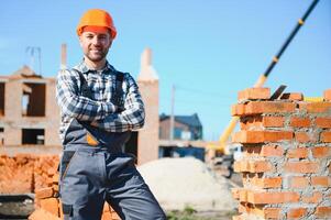 Construction worker in uniform and safety equipment have job on building photo