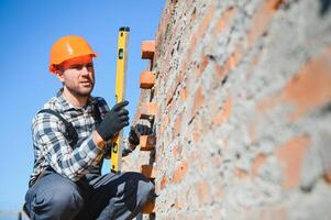 Portrait of a builder in the process of working on a construction site outdoors photo