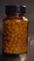 An Amber Bottle Filled with Herbal Supplements Set Against a Natural Background Setting video