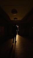 A Mysterious Dimly Lit Hallway Accompanied by an Open Door at the End of the Passageway video