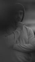 A Mysterious Figure Dressed in a Hoodie Surrounded by an Artistic Blur of Colors and Shapes video